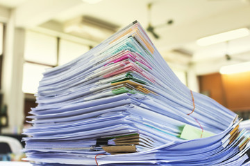 Pile of documents on desk at workplace
