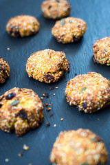 Homemade oatmeal Cookies with Berries and Sesame Seeds on Dark Stone Background, Vertical View