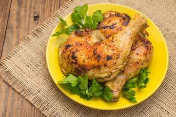 Roasted chicken legs on a wooden background. Top View. Close-up