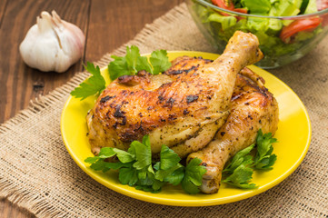Roasted chicken legs on a wooden background. Top View. Close-up