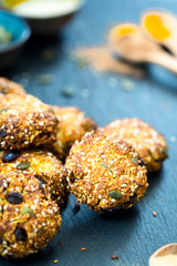 Shortbread with Seeds, Nuts and Dried Fruits on Dark Stone Background, Vertical View