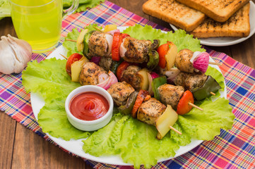 Skewers of chicken and vegetables on wooden . Rural background. Close-up