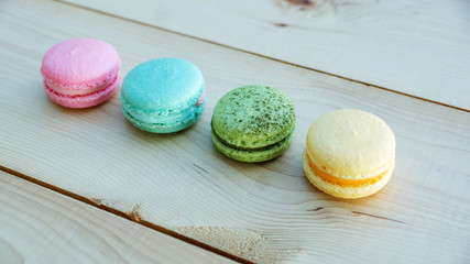 colorful cake macaron or macaroon on wooden background.