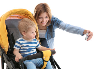 Mother with baby in pram taking photo