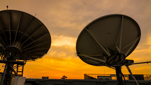 Satellite dishe. Sunset sky background