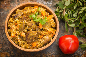 Uzbek pilaf - a dish consisting of rice and meat. Old background. Top view. Close-up