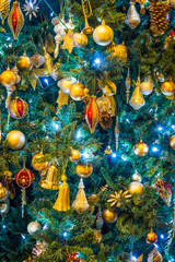 Fully Christmas ornaments and decorations. Lights and baubles are used to festoon a tree.