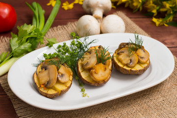 Baked potatoes with fried mushrooms. Top view. Close-up