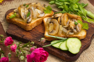 Toast with fried mushrooms and vegetables on the background color. Close-up