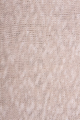 Beige knitted fabric texture.
