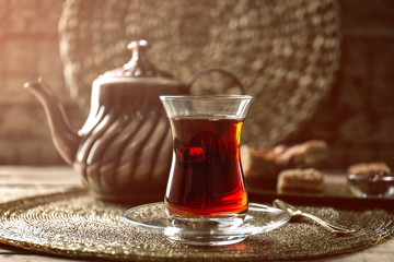 Turkish tea in traditional glass on tray closeup