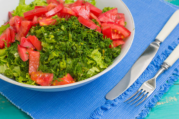 Summer vegetable salad on a wooden turquoise background. Close-up