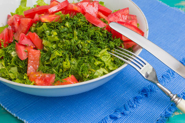 Summer vegetable salad on a wooden turquoise background. Close-up