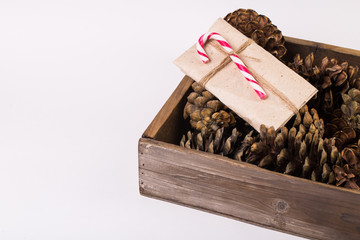 Christmas gift tied with ribbon and pine cone isolated on white background