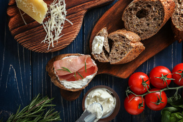 Fresh ingredients for tasty toasts on wooden table
