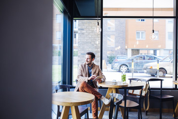 Man Sitting in Coffee Shop