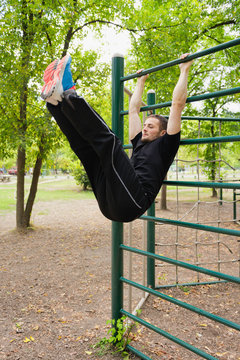 stall bar exercise. Young athlete exercising on stall bars