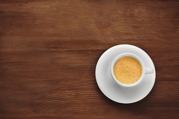 Cup of coffee on wooden background