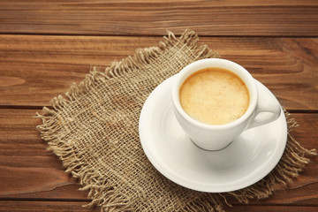 Cup of coffee on wooden background