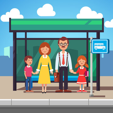 Family Waiting For Transit On A City Bus Stop