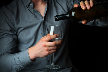 Obraz na płótnie Canvas Drunk man with lipstick stamps pouring wine into glass