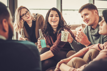 Group of multi ethnic young friends having fun in home interior