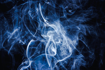 Fototapeta premium Artistic blue smoke on black background texture.