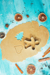 metal molds on dough men tree a blue wooden background