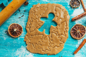 Gingerbread dough with molds for baking cinnamon on blue wooden table