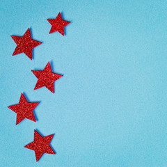 Fototapeta na wymiar Red Shining Stars on Blue