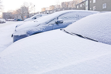 Snow and ice covers on parked cars