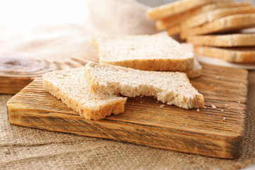 Sliced bread on wooden cutting board closeup