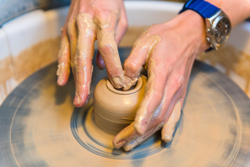 womens hands of a potter creating an earthen jar