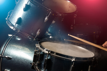 The man is playing drumset
