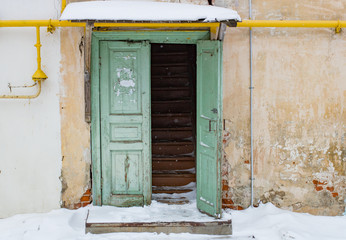 The old porch of a wooden house entry winter