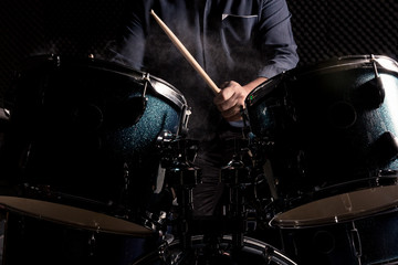 The man is playing drumset