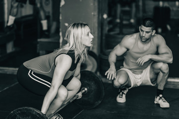 Fototapeta na wymiar Weightlifting training. Trainer and female on training
