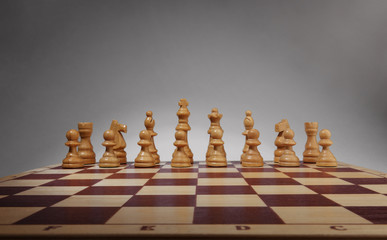 Chessboard with chess pieces. White set, front wide view angle. © gedzun