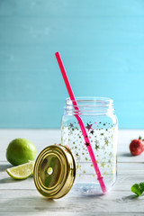 Empty mason jar with lime on wooden table