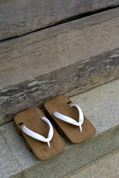 Pair of traditional wooden monk's geta (sandals) at the steps of a Buddhist temple on Mount Koya, Wakayama, Japan