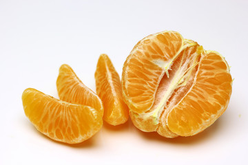 Mandarin, tangerine citrus fruit isolated on white background. Pile of a fresh oranges and several segment of peeled citrus.
