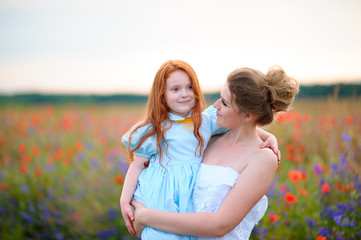Fototapeta na wymiar Happy family on a summer meadow. little girl child baby daughter