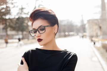 Young stylish woman walking in a city street