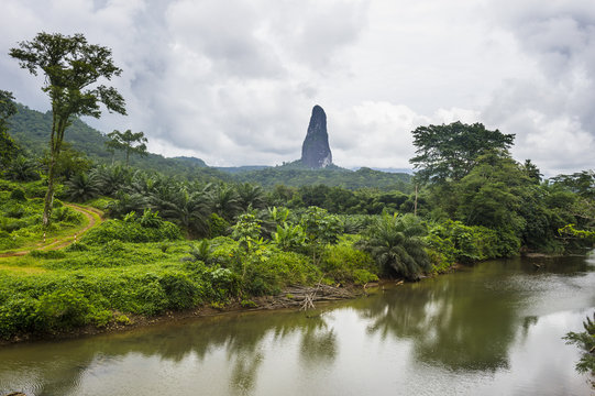 River flowing before the unusal monolith, Pico Cao Grande, east coast of Sao Tome, Sao Tome and Principe, Atlantic Ocean