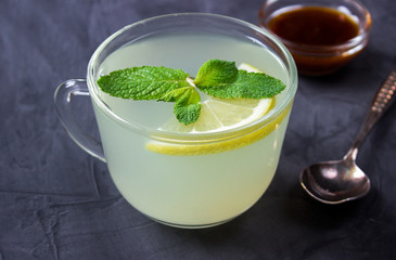 Closeup of Cup of Ginger tea with lemon and mint