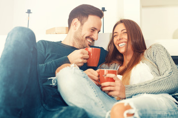 Happy young couple at home - Powered by Adobe