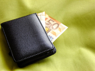 Wallet on greenish Textile Background