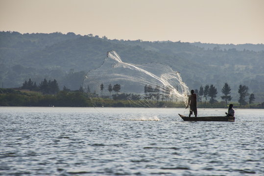 Local fisherman in a dug-out canoe in Jinja, Uganda