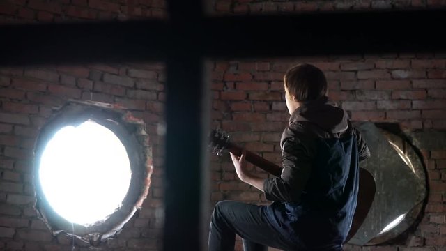 young boy playing a guitar