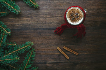 Coffee cup with cinnamon and fir on dark background